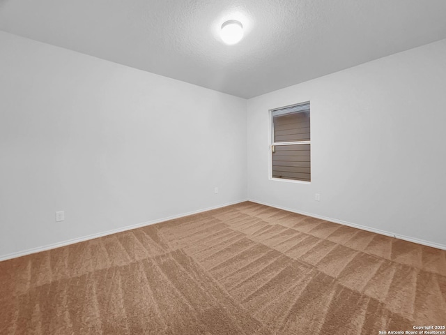 carpeted empty room with a textured ceiling