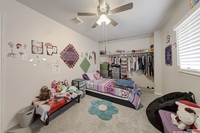 carpeted bedroom featuring a closet and ceiling fan