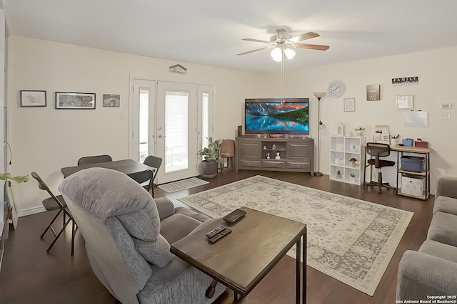 living room featuring dark hardwood / wood-style floors, ceiling fan, and french doors