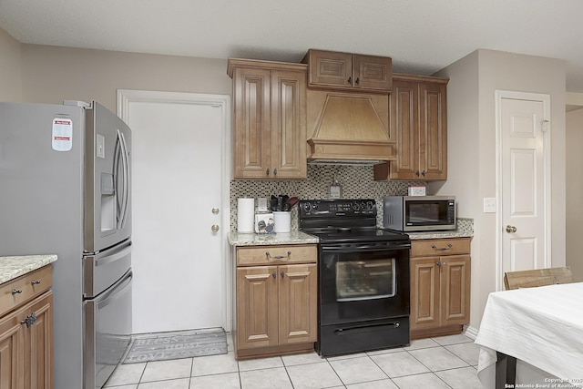 kitchen featuring custom exhaust hood, light tile patterned floors, appliances with stainless steel finishes, light stone countertops, and decorative backsplash