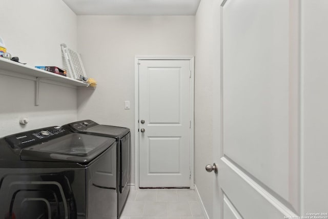 washroom featuring light tile patterned floors and washing machine and clothes dryer