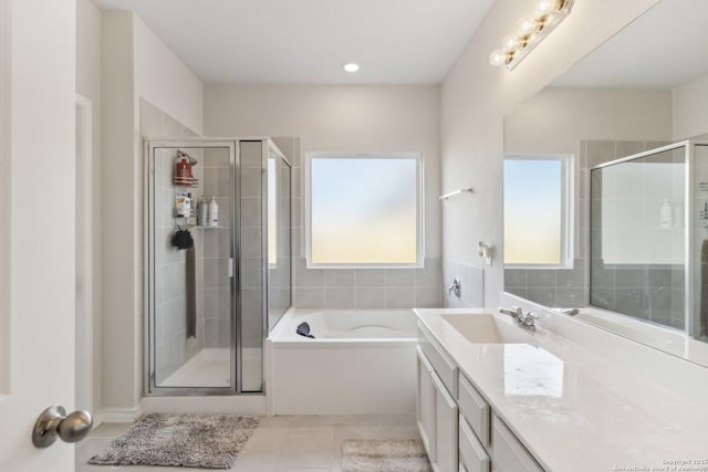 bathroom with tile patterned floors, vanity, and independent shower and bath