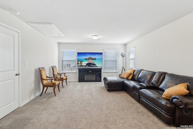 living room featuring light carpet and a fireplace