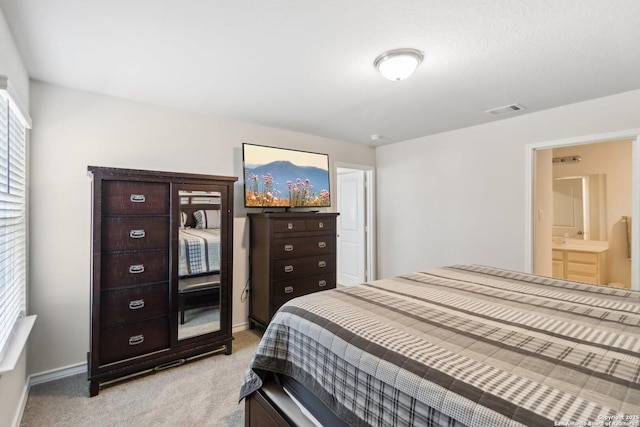 carpeted bedroom featuring ensuite bathroom