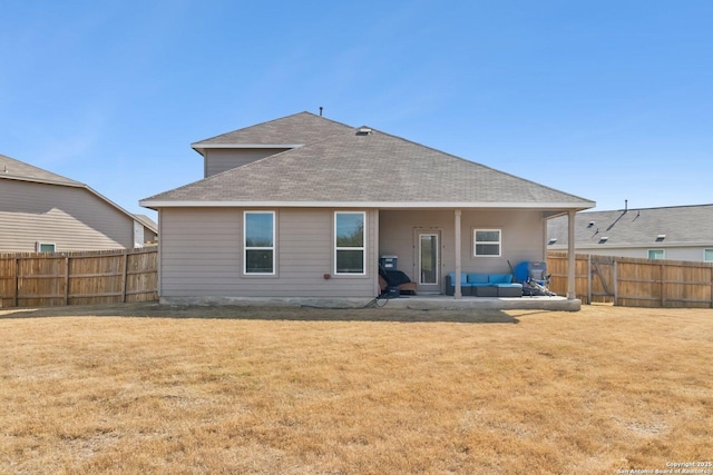 rear view of house featuring a patio area and a lawn