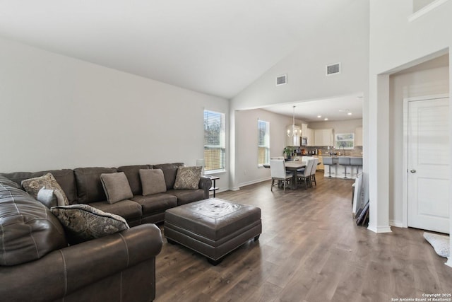 living room featuring dark wood-type flooring and high vaulted ceiling