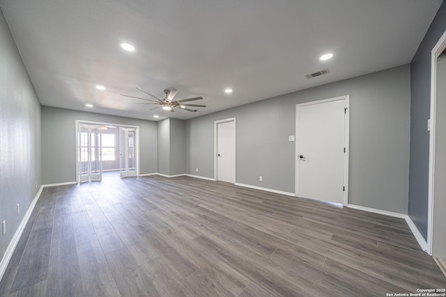 empty room with hardwood / wood-style flooring and ceiling fan