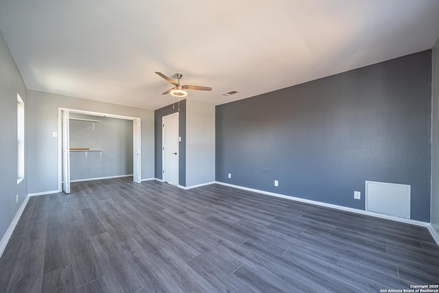 unfurnished bedroom with ceiling fan, dark hardwood / wood-style floors, and a closet