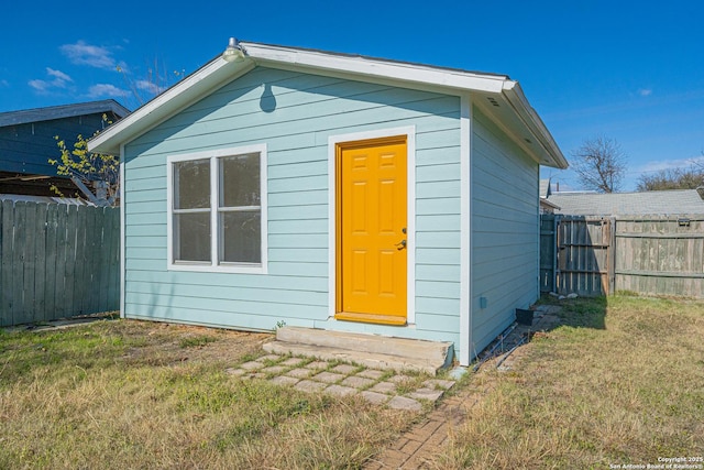 view of outbuilding with a yard