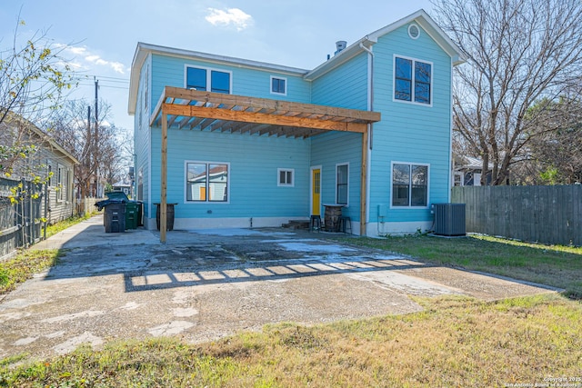 back of property featuring central AC