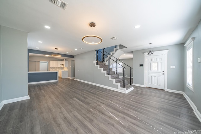 unfurnished living room with dark wood-type flooring