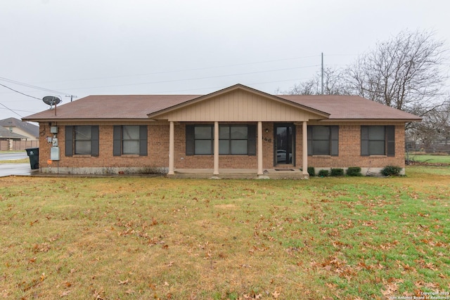 single story home with brick siding and a front yard