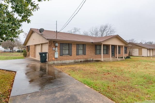 single story home with concrete driveway, brick siding, and a front yard