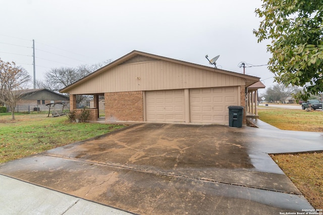 view of home's exterior with a garage and a lawn