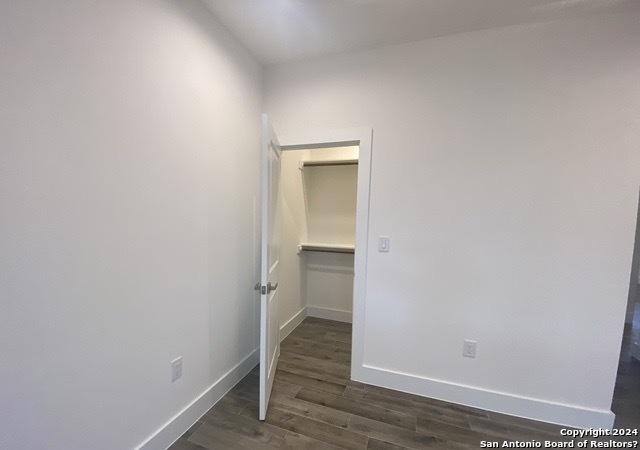 spare room featuring dark hardwood / wood-style flooring