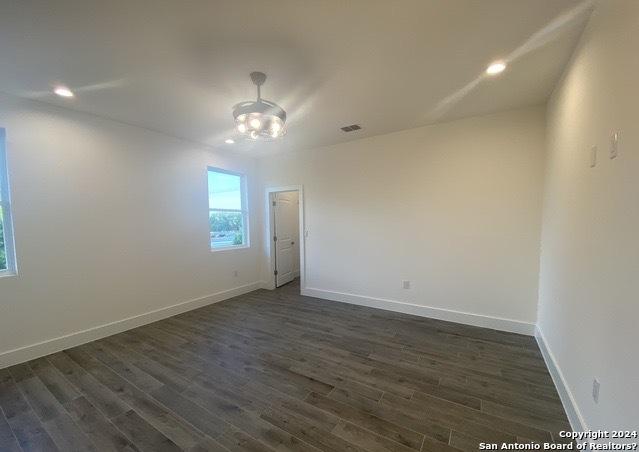 unfurnished room featuring dark wood-type flooring