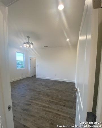 unfurnished room with dark hardwood / wood-style flooring