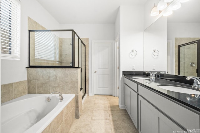 bathroom with tile patterned floors, separate shower and tub, and vanity