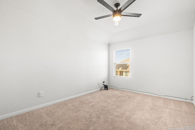 carpeted empty room with ceiling fan and lofted ceiling