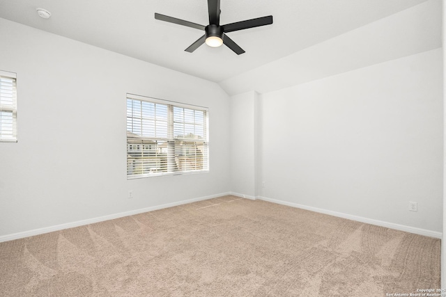 carpeted spare room with lofted ceiling and ceiling fan