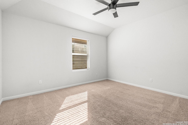 carpeted spare room with lofted ceiling and ceiling fan