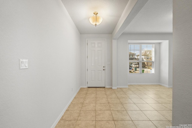 tiled entrance foyer featuring a textured ceiling