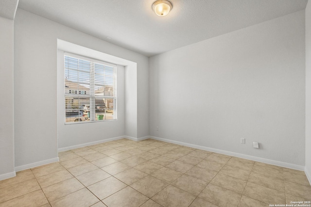 spare room featuring light tile patterned floors