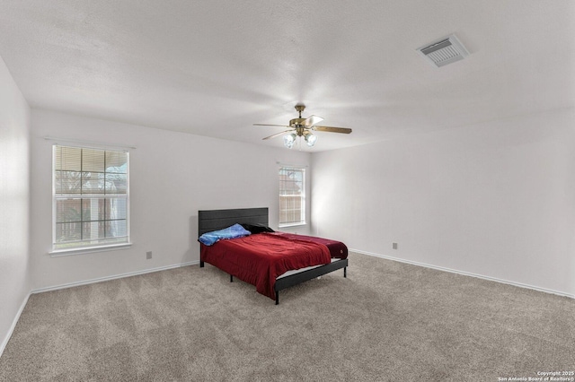 bedroom featuring light carpet and ceiling fan