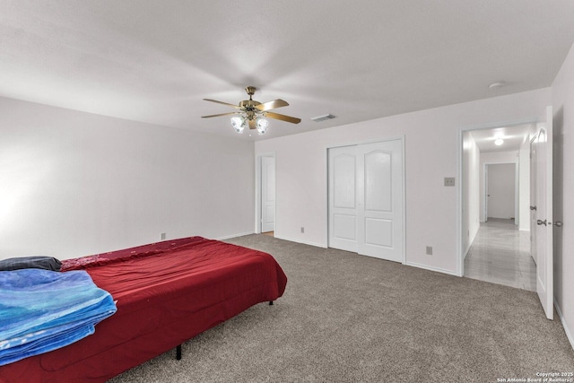 bedroom with carpet flooring, ceiling fan, and a closet