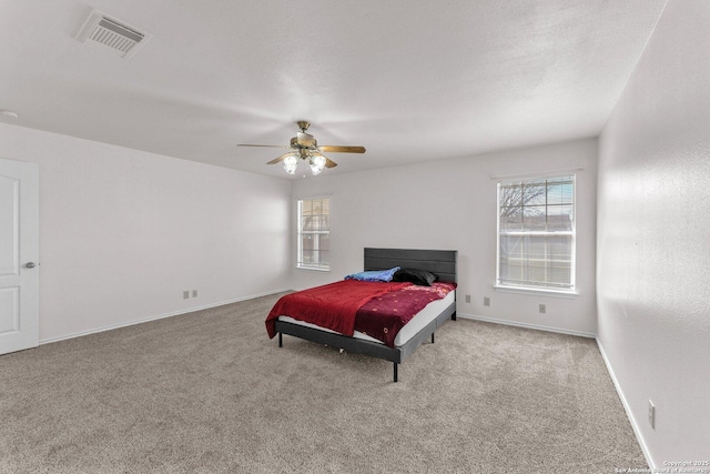 bedroom featuring light colored carpet and ceiling fan