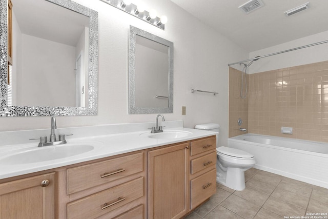 full bathroom featuring tiled shower / bath, tile patterned floors, toilet, and vanity