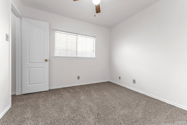 spare room featuring carpet and ceiling fan