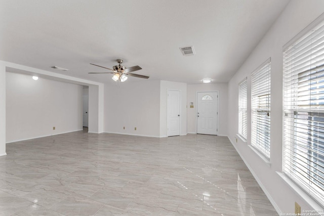 unfurnished living room with ceiling fan