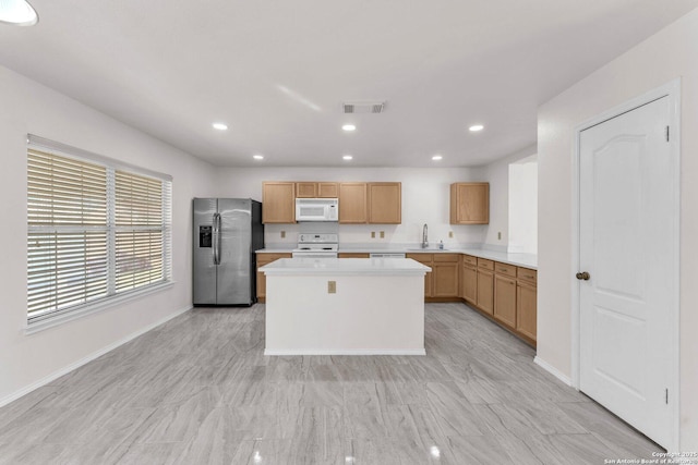 kitchen with sink, white appliances, and a center island