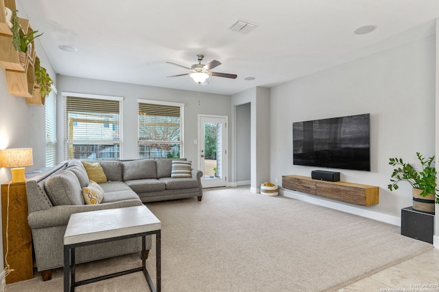 carpeted living room featuring ceiling fan