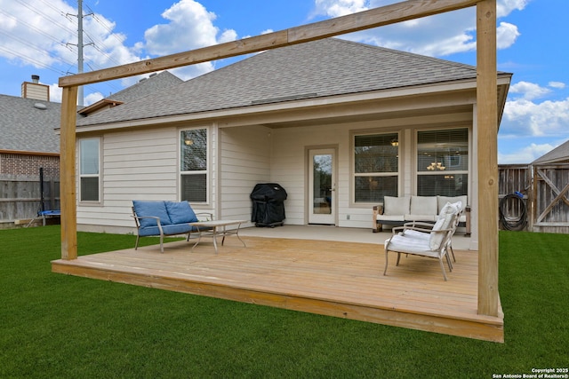 rear view of house with outdoor lounge area, a yard, and a deck