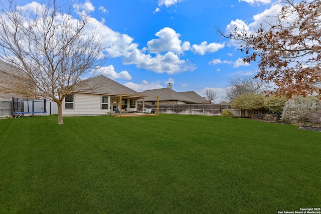 back of house with a storage shed, a yard, and a patio area