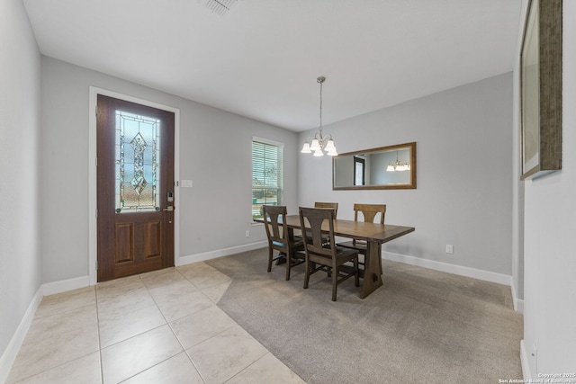 dining area with an inviting chandelier and light tile patterned flooring