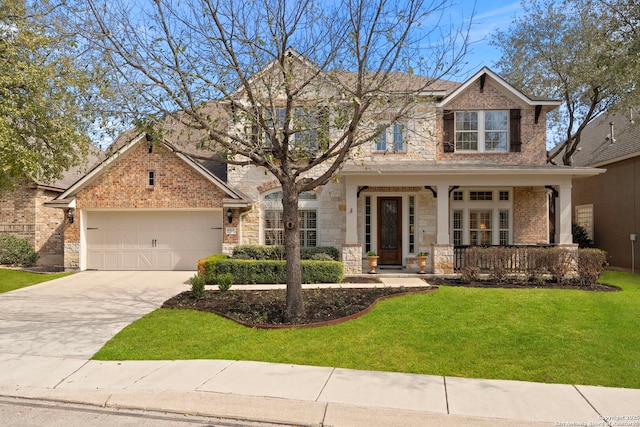 view of front of property with a porch, an attached garage, driveway, stone siding, and a front lawn