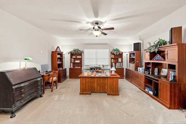 home office featuring ceiling fan, a textured ceiling, and light colored carpet