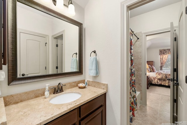 full bath with a shower with curtain, ensuite bath, tile patterned floors, and vanity