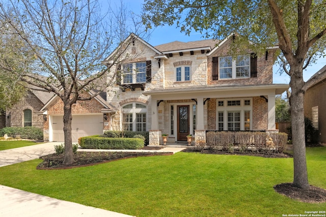 view of front of house featuring driveway, stone siding, an attached garage, covered porch, and a front yard