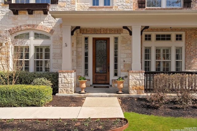 property entrance featuring a porch and stone siding