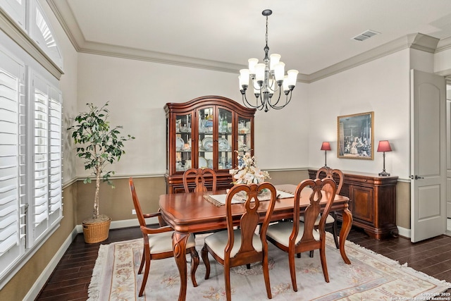 dining space featuring an inviting chandelier, visible vents, wood finished floors, and ornamental molding