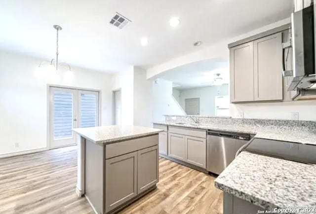 kitchen featuring gray cabinetry, stainless steel dishwasher, and a kitchen island