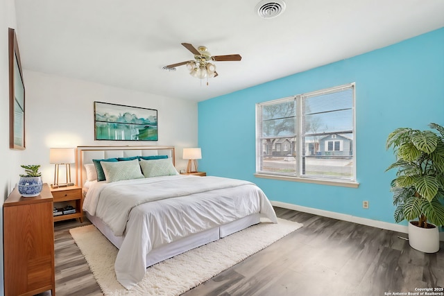 bedroom with ceiling fan and dark hardwood / wood-style floors