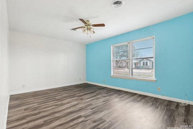 empty room featuring dark hardwood / wood-style flooring and ceiling fan