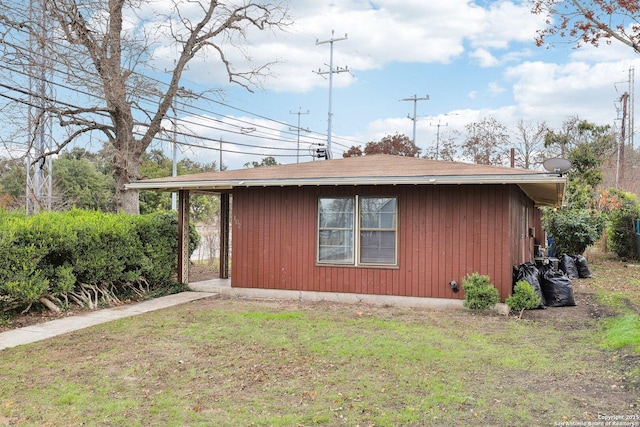 view of property exterior with a lawn