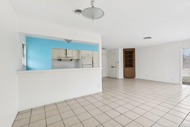 unfurnished living room with light tile patterned floors