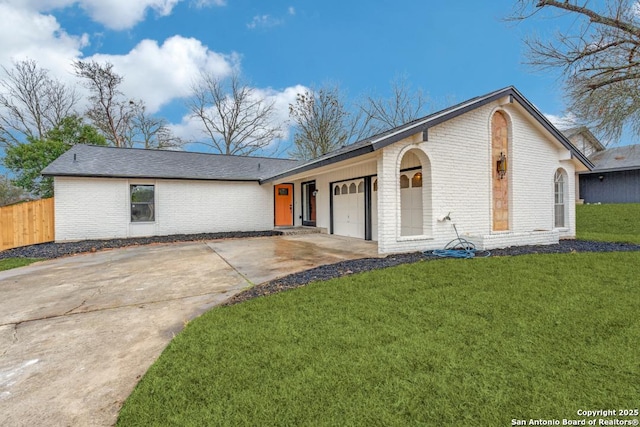 ranch-style house with a garage and a front lawn